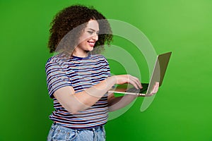 Profile photo of nice positive girl toothy smile hold use wireless laptop isolated on green color background
