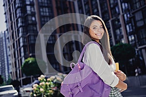 Profile photo of positive attractive girl toothy smile hold rucksack diary book modern city center outside