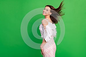 Profile photo of positive lovely girl toothy smile flying hairstyle isolated on green color background