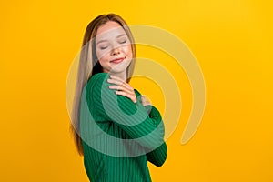 Profile photo of pretty lovely girl closed eyes hands embrace shoulders empty space isolated on yellow color background