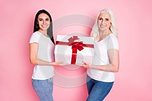 Profile photo of pretty old mother young daughter ladies holding large gift box present hands son grandson birthday wear