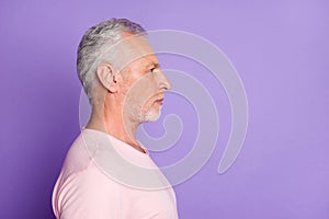 Profile photo of retired old man calm expression look empty space wear pink t-shirt isolated violet color background