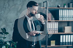 Profile photo of successful business guy self-confident person hold coffee beverage mug plate look window thoughtful