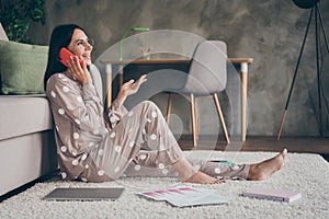 Profile photo of sweet optimistic girl sit talk telephone wear spectacles pijama at home