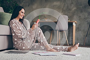Profile photo of sweet optimistic girl sit write telephone wear spectacles pijama at home photo