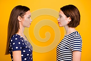 Profile photo of two amazing ladies standing opposite hate each other deciding who is better wear casual dotted and