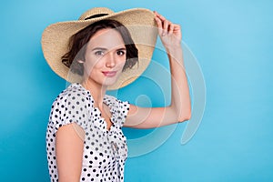 Profile portrait of adorable stunning lady hand touch sun hat look camera isolated on blue color background