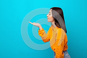 profile portrait of amazing funny mixed races woman sending air kiss