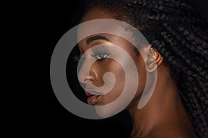 profile portrait of beautiful african american woman with water drops on face looking away