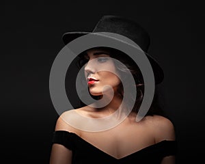 Profile portrait of a beautiful lady wearing a black hat