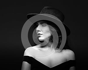 Profile portrait of a beautiful lady wearing a black hat