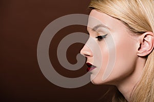profile portrait of beautiful young blonde woman looking away