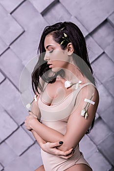 Profile portrait of supermodel crossing arms in studio photo session photo