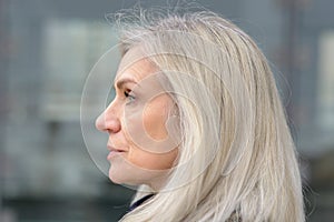 Profile portrait of a blond middle-aged woman