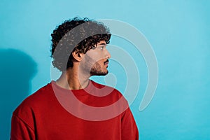 Profile portrait of focused concentrated young man calm face look empty space isolated on blue color background