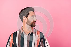 Profile portrait of focused concentrated young man calm face look empty space isolated on pink color background