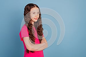 Profile portrait of lovely sweet small girl crossed hands look blank space on blue background