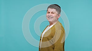 Profile portrait positive adult man looking at camera with toothy smile