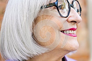 profile portrait of a senior woman smiling happy