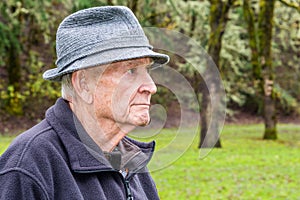 Profile Portrait of Serious Older Man with Grey Tweed Rain Hat a
