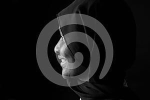 Profile portrait of a woman with burqa on black background