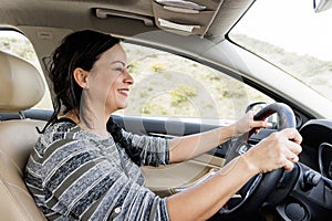 Profile portrait of a woman smiling while driving