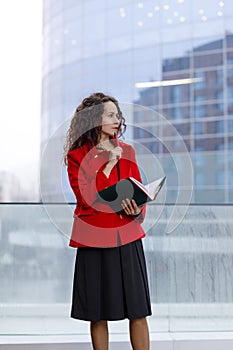 Profile portrait of a woman, working, construction specialist, real estate agent, making notes on the agenda