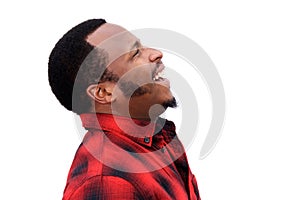 Profile portrait of young black man laughing and looking up