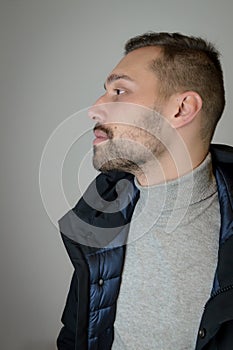 Profile portrait of a young brown-haired man with a short beard