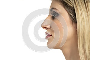 Profile portrait of a young woman with a humpbacked nose on a white background