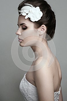 Profile of pretty bride with flower in her hair