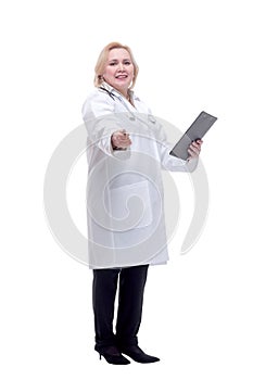 Profile of a pretty doctor with white lab coat, stethoscope smiling and writing notes in clipboard