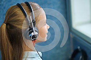 Profile of pretty girl in special headphones