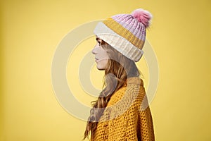 Profile shot attractive female curly hairstyle wearing hat knitted sweater standing queue order hot warm drink look left