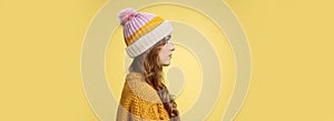 Profile shot attractive female curly hairstyle wearing hat knitted sweater standing queue order hot warm drink look left