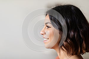 Profile Shot Of Beautiful Smiling Young Arab Woman Standing Indoors