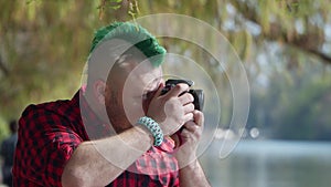 Profile shot of man taking photo at park
