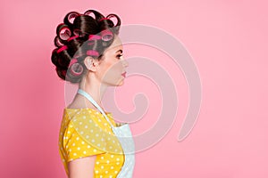 Profile side photo of attractive girl look copyspace wear retro outfit hair rollers  over pink color background