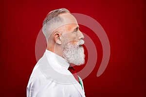 Profile side photo of charming old grandfather look empty space showman isolated on red color background