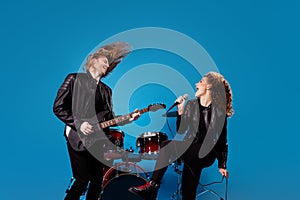 Profile side photo funky youth two people team man play bass guitar woman sing mic rock composition enjoy tour event