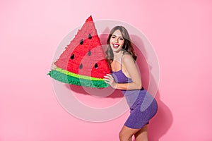Profile side photo of happy joyful woman hold pinata watermelon smile isolated on pink color background