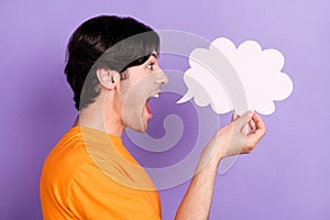 Profile side photo of happy positive young man hold hand cloud banner news isolated on purple color background