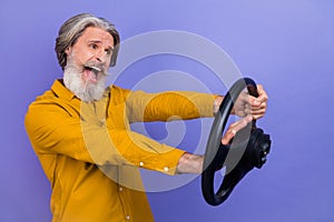 Profile side photo of mature man mad look empty space ride auto vechicle conflict isolated over purple color background