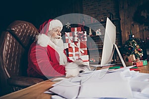 Profile side photo shocked grey beard santa claus sit table use computer check email impressed wish list letters wear