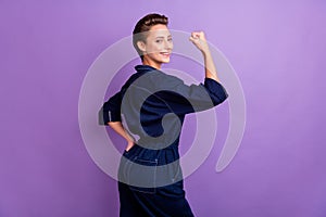 Profile side photo of smiling confident strong brave woman raise fist feminism isolated on purple color background