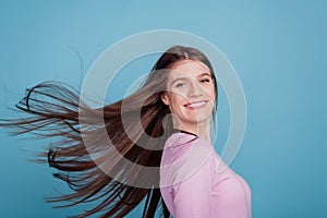 Profile side photo of youg beautiful girl wind blowing hair healthy condition lotion  blue color background