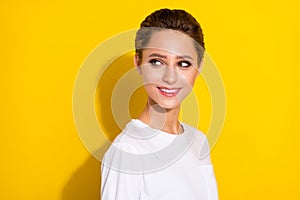 Profile side photo of young attractive girl happy positive smile dream curious look empty space isolated over yellow