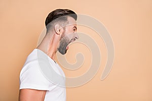 Profile side photo of young handsome man unhappy angry mad crazy yell look empty space isolated over beige color