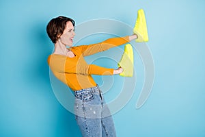 Profile side photo of young happy excited crazy girl hold sneakers on hand advertise isolated on blue color background