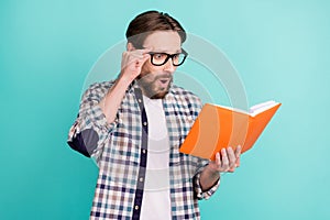 Profile side photo of young man amazed shocked surprised read book fake novelty isolated over teal color background